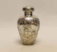 An Edwardian continental embossed silver tea caddy? and cover decorated with amorini, makers stamp