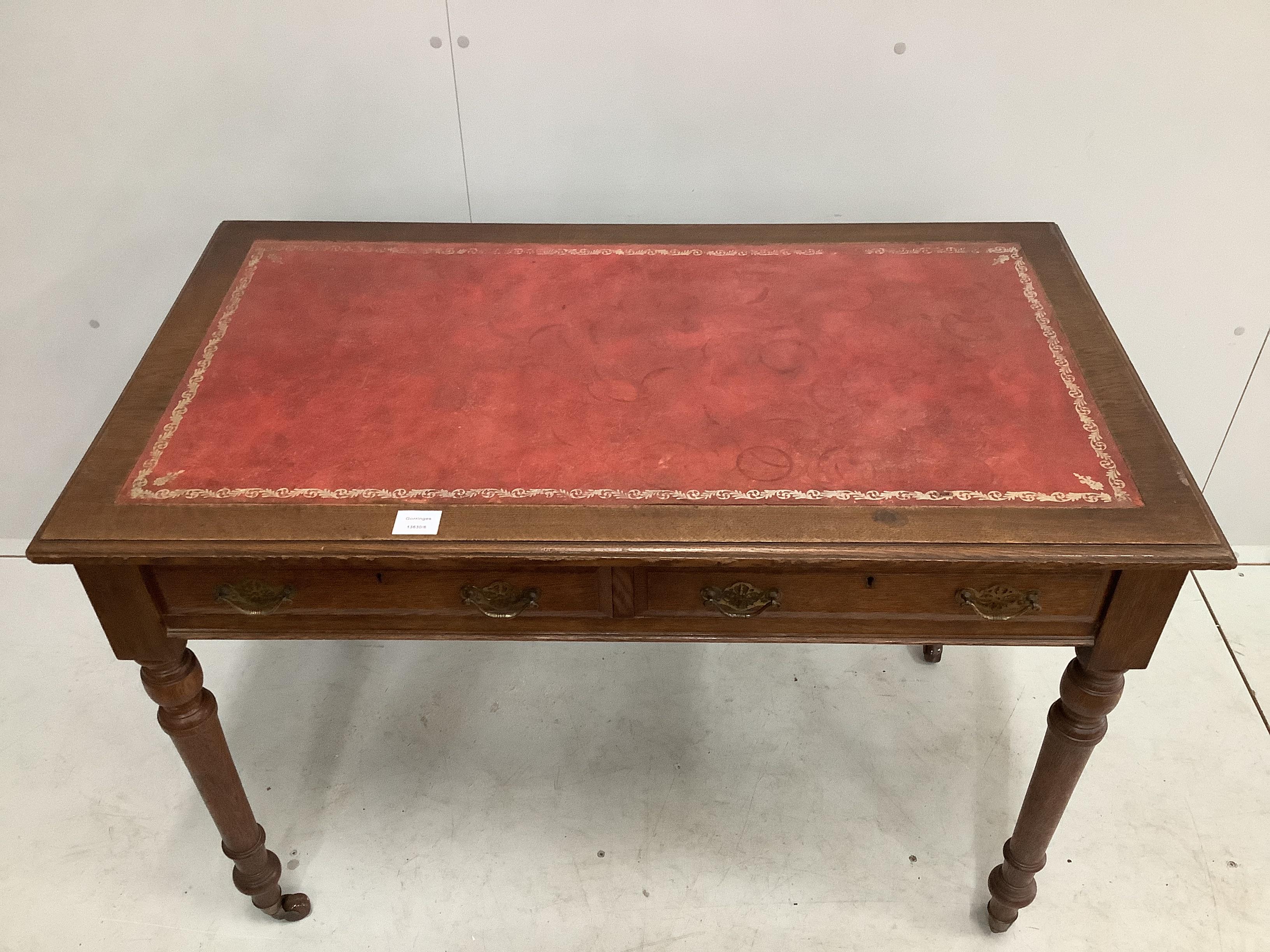 A late Victorian oak two drawer writing table, with red leather inset top, width 106cm, depth - Image 2 of 2