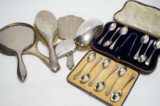 Two cased sets of six silver teaspoons, assorted silver mounted brushes and damaged mirror and a