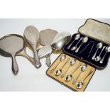 Two cased sets of six silver teaspoons, assorted silver mounted brushes and damaged mirror and a