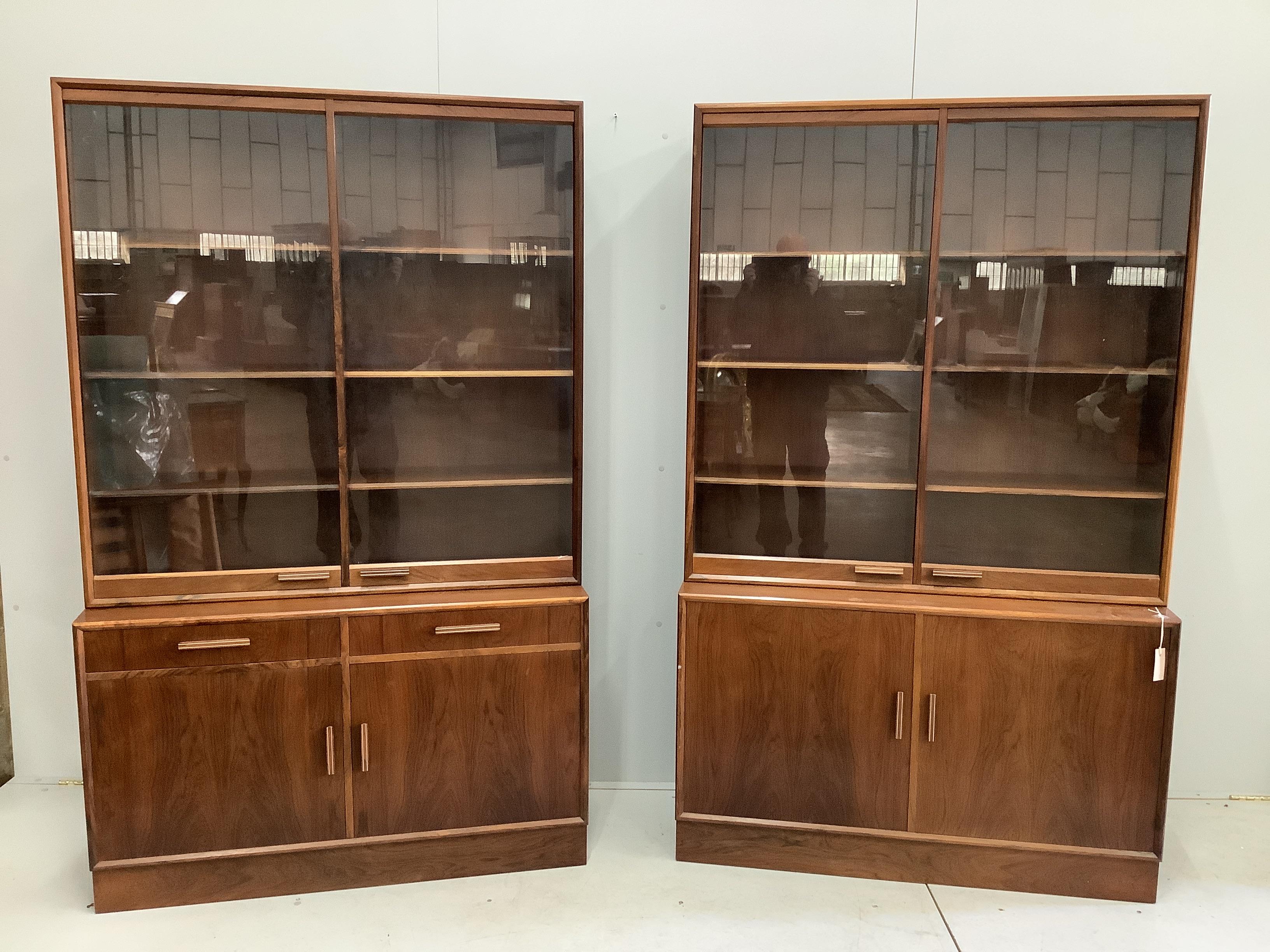 A pair of mid century Indian rosewood glazed cabinets with adjustable shelves, width 110cm, depth