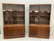A pair of mid century Indian rosewood glazed cabinets with adjustable shelves, width 110cm, depth