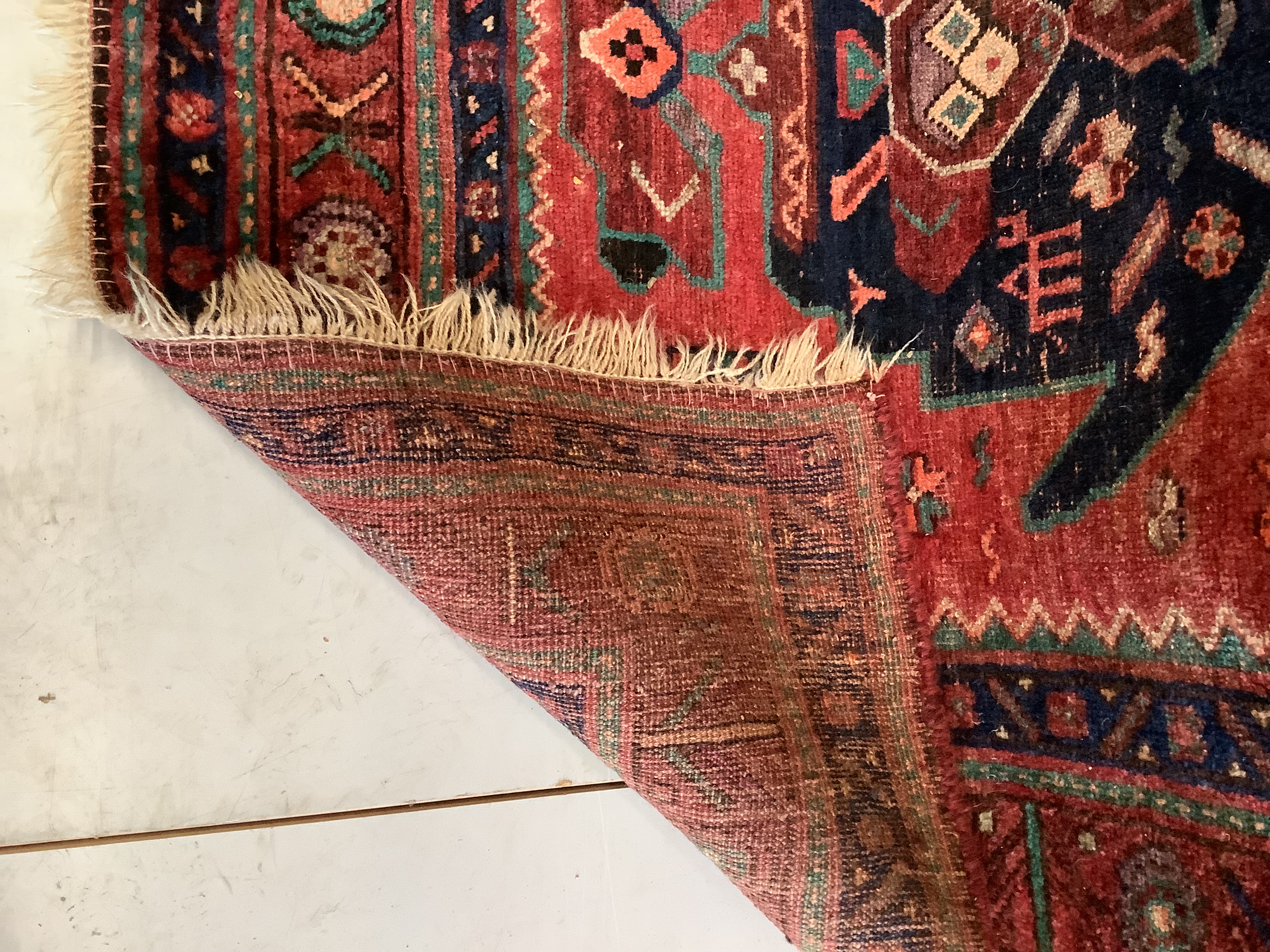 An Heriz red ground medallion rug with triple medallions on a brick red ground, multi bordered, - Image 3 of 7