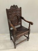 A 19th century oak panel back wainscot armchair, width 57cm, depth 54cm, height 117cm