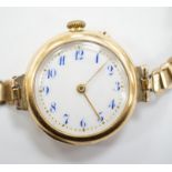 An early 20th century 15ct gold manual wind wrist watch, on a rolled gold bracelet.