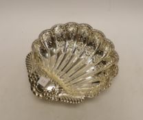 A George V pierced silver scallop shaped bowl, on fluted ball feet, Atkin Brothers, Sheffield, 1902,