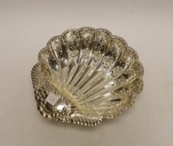 A George V pierced silver scallop shaped bowl, on fluted ball feet, Atkin Brothers, Sheffield, 1902,