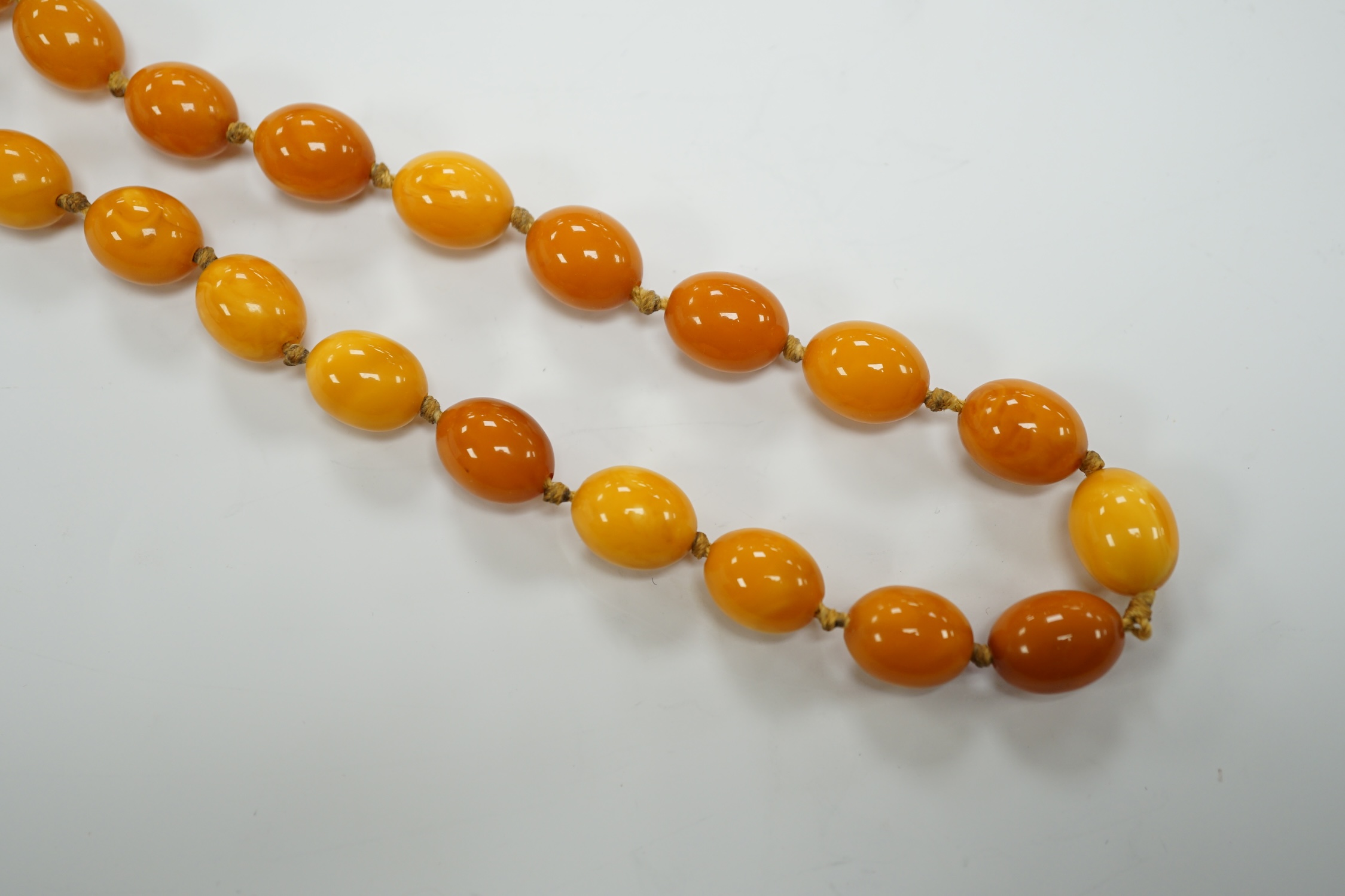 A long single strand oval amber bead necklace, 156cm, gross weight 89 grams. - Image 6 of 9