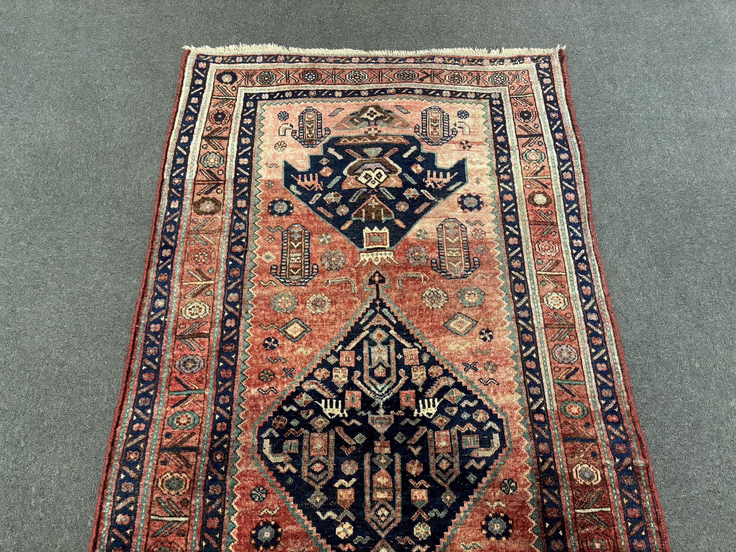 An Heriz red ground medallion rug with triple medallions on a brick red ground, multi bordered, - Image 5 of 7