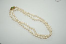 A single strand cultured pearl necklace, with 14k and jade set clasp, 40cm.
