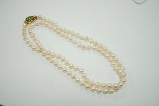 A single strand cultured pearl necklace, with 14k and jade set clasp, 40cm.