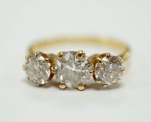 A George V 18ct gold and three stone diamond set ring, the central stone weighing approx. 0.60ct,
