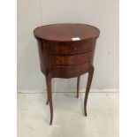 A French oval kingwood three drawer occasional table, width 39cm, depth 30cm, height 75cm
