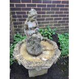 A circular reconstituted stone figural bird bath, height 102cm