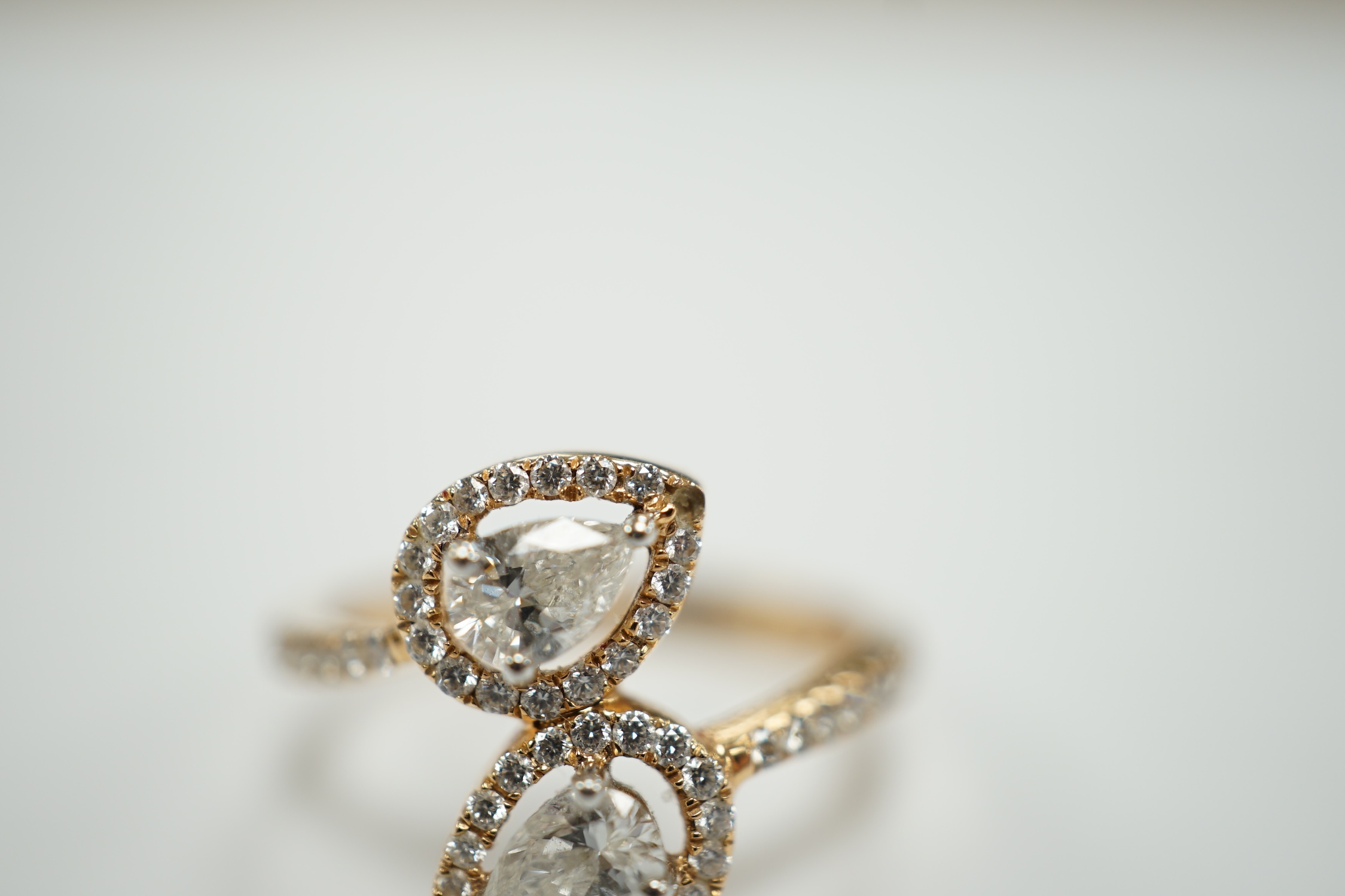 A modern 18k and two stone pear cut diamond set cross-over ring, with diamond chip border and - Image 2 of 5