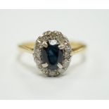 An 18ct, sapphire and diamond set oval cluster ring, size L, gross weight 2.5 grams.