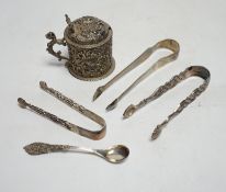 A Victorian silver embossed mustard pot, with spoon and three pairs of George III and later silver