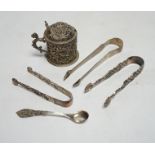 A Victorian silver embossed mustard pot, with spoon and three pairs of George III and later silver