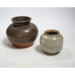 A Chinese brown partially glazed jar and a celadon jar, Song Dynasty largest 13cm in diameter