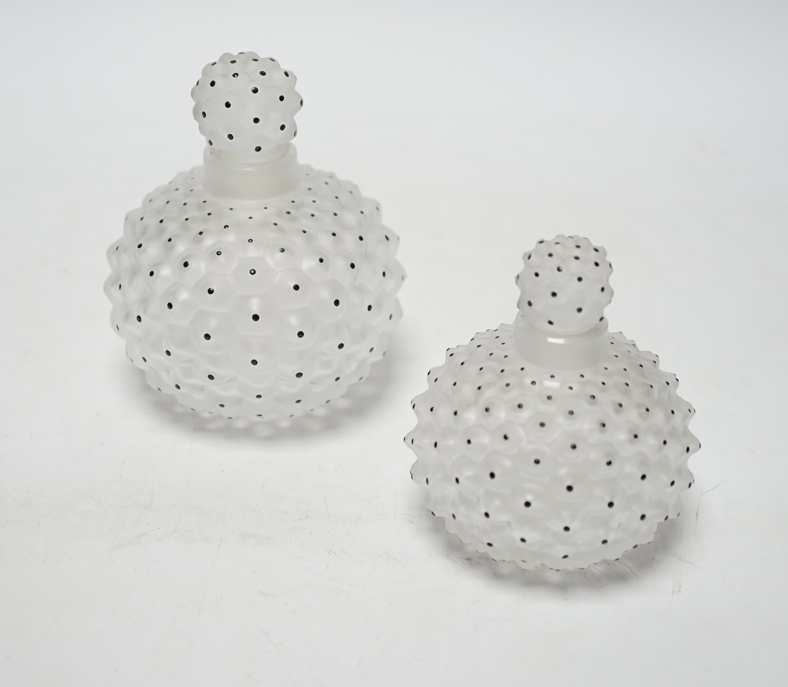 Two Lalique graduated cactus pattern glass scent bottles and stoppers, one with label to the base,