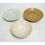 Two Chinese qingbai dishes and a Yue ware bowl, Song-Yuan dynasty, widest 17cm diameter