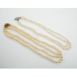 A single strand cultured pearl necklace, with turquoise? and seed pearl set 9ct clasp, 56cm and a