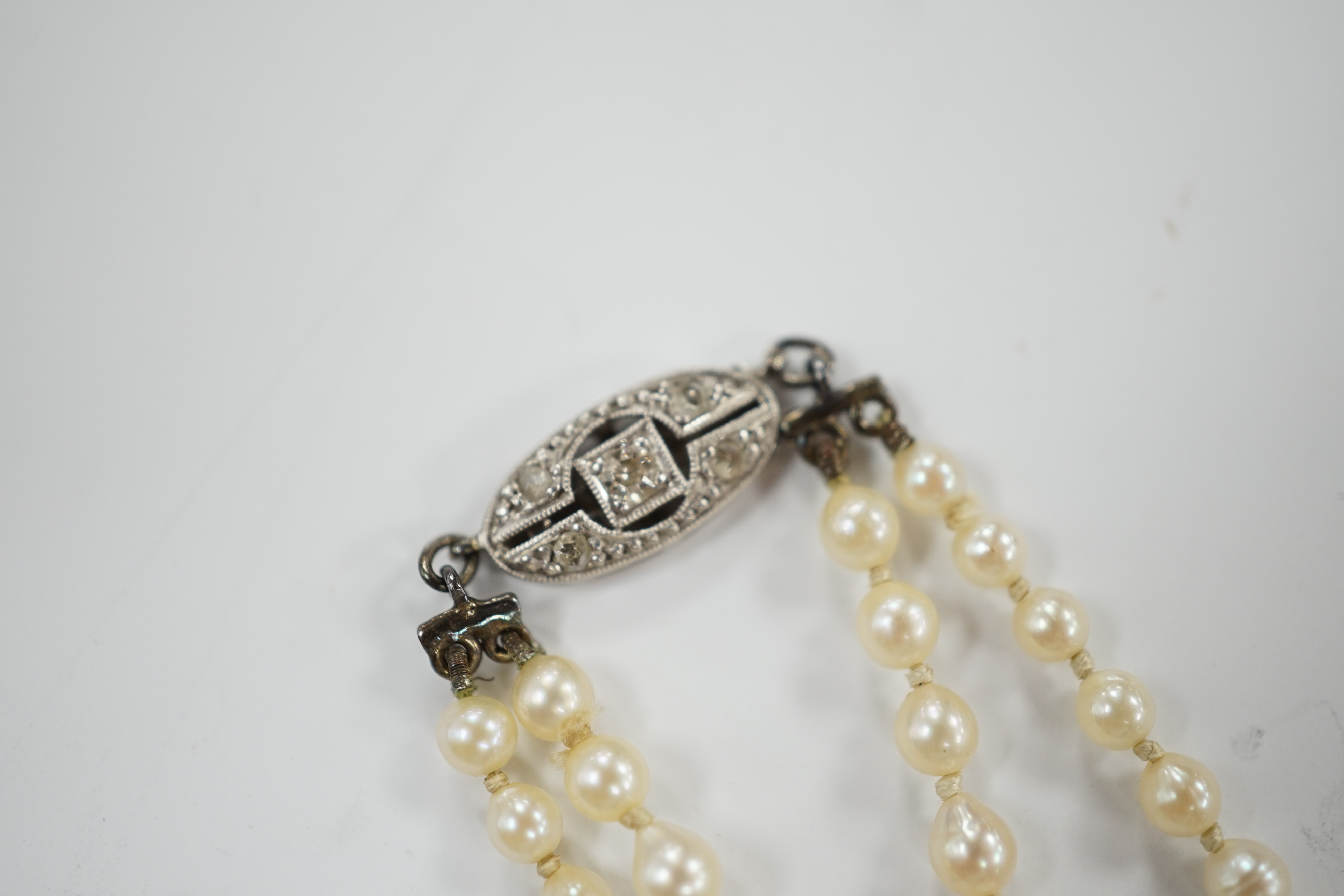 A 1930's twin strand graduated cultured pearl necklace, with 14ct, plat and diamond chip set - Image 4 of 4