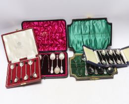 Four assorted sets of six coffee or tea spoons, including two with sugar tongs.