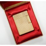 A cased gold plated Dupont lighter with booklet