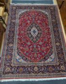 A Tabriz burgundy ground carpet, 292 x 216cm