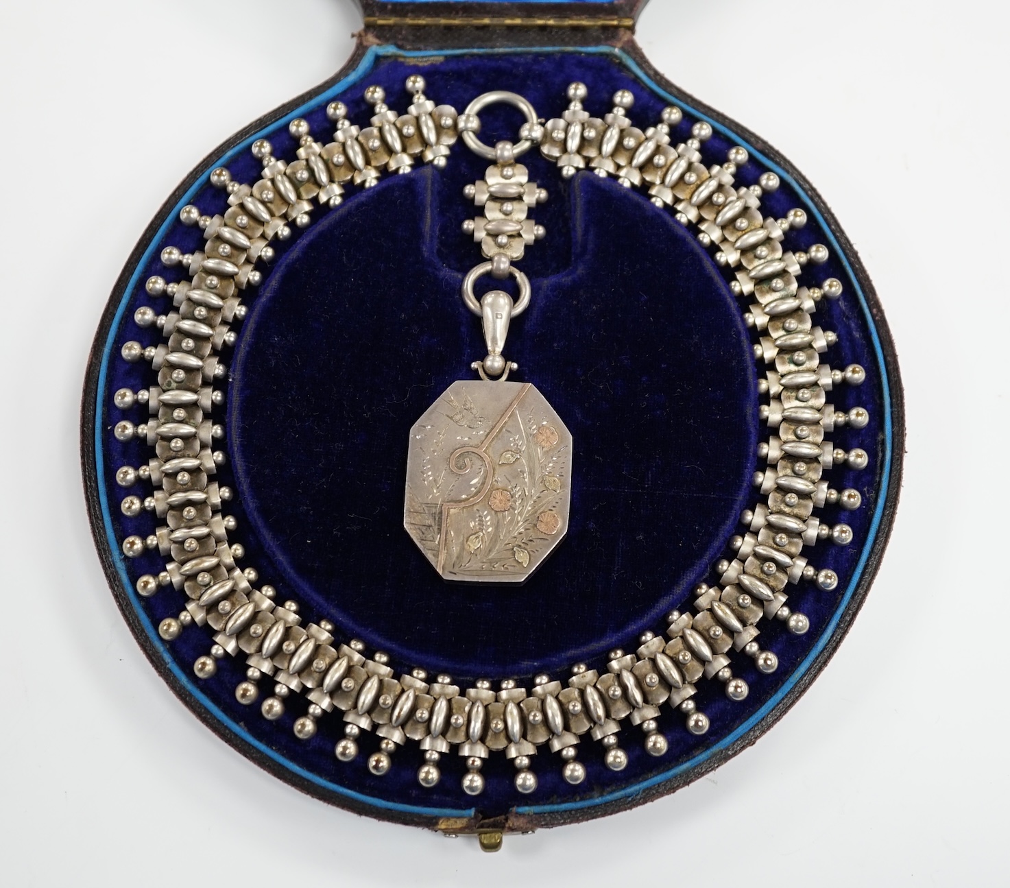 A Victorian silver octagonal locket with engraved aesthetic decoration, Birmingham, 1881, 43mm, on a