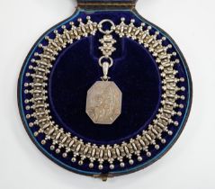 A Victorian silver octagonal locket with engraved aesthetic decoration, Birmingham, 1881, 43mm, on a