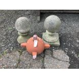 A pair of reconstituted stone ball finials, height 36cm together with a terracotta finial