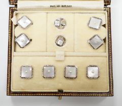 A 9ct white metal, mother of pearl and seed pearl set eight piece dress stud set, in fitted gilt