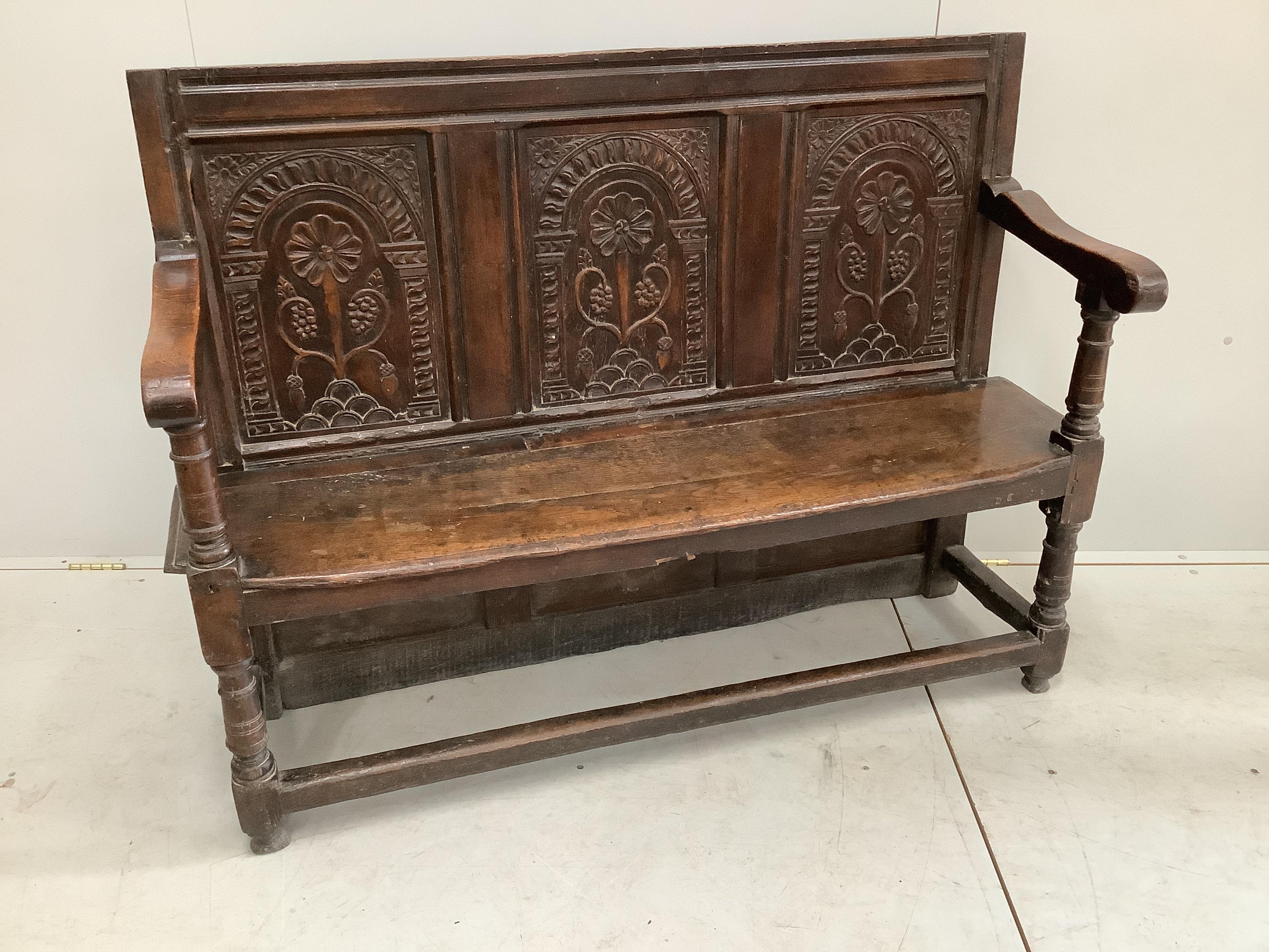 An 18th century style oak settle, incorporates old timber, width 130cm, depth 44cm, height 99cm