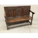 An 18th century style oak settle, incorporates old timber, width 130cm, depth 44cm, height 99cm