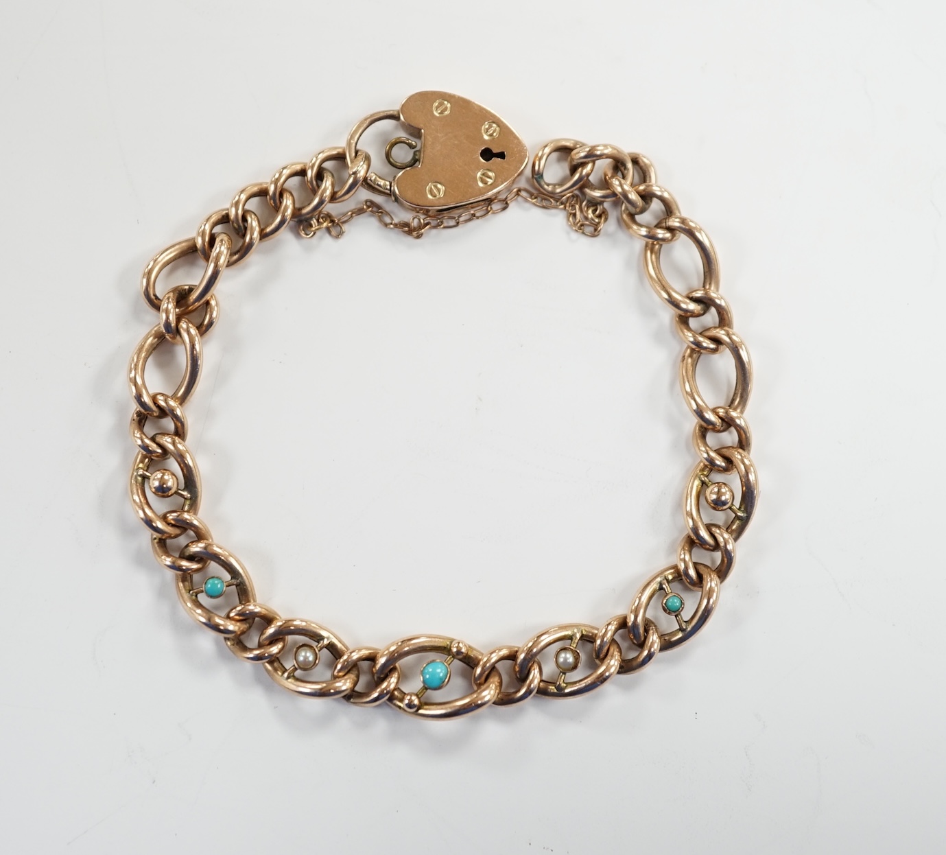A 9ct gold and turquoise bead set curb link bracelet, with heart shape padlock clasp, 18cm, gross