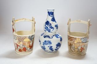 A Chinese blue and white double gourd vase and two Japanese Satsuma baskets, tallest 16cm