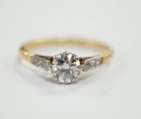 An early 20th century yellow metal and single stone diamond set ring, with diamond chip set