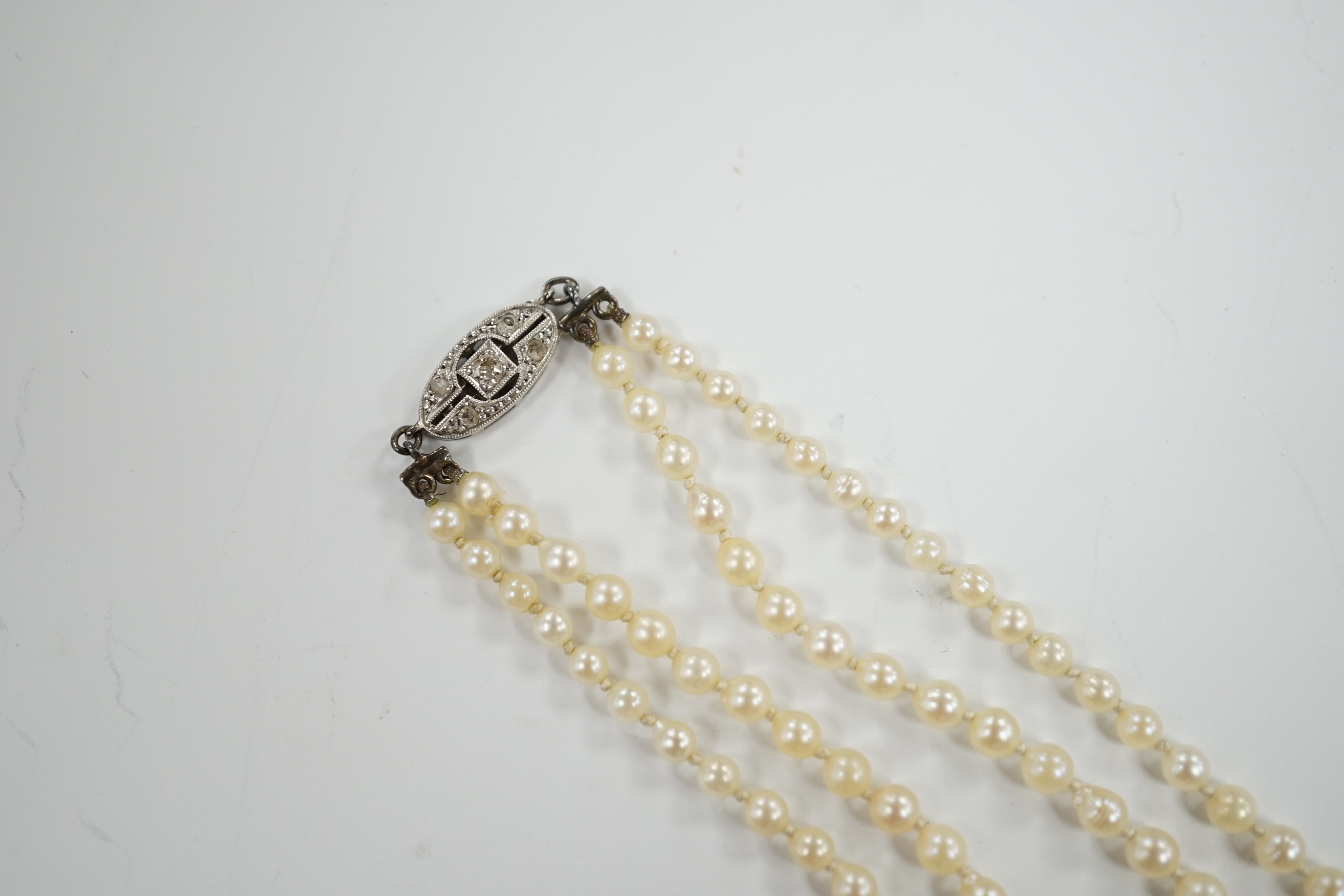 A 1930's twin strand graduated cultured pearl necklace, with 14ct, plat and diamond chip set - Image 3 of 4