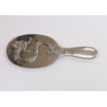 A Chinese Export white metal mounted oval hand mirror, decorated with a dragon, 25.2cm.