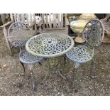 A Victorian style aluminium circular garden table, diameter 62cm, height 63cm and two chairs