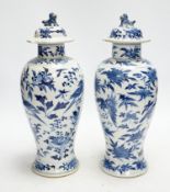 A pair Chinese blue and white vases, late 19th century, with lion-dog covers, 32cm high