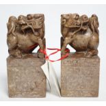 A pair of Chinese soapstone lion-dog and cub seals, 19cm high