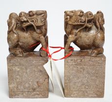 A pair of Chinese soapstone lion-dog and cub seals, 19cm high