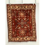 Two Turkish red ground rugs, larger 156 x 130cm