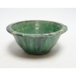 A Chinese green glazed bowl, Yuan-Ming dynasty, 19cm diameter