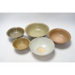 A group of four Chinese Longquan or Yue ware celadon bowls and a Qingbai bowl, Song-Yuan dynasty,