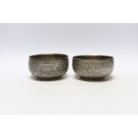 A pair of Indian embossed white metal finger bowls, 10cm, 7.5oz.