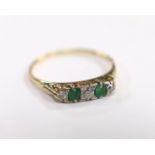 An 18ct, two stone emerald and three stone diamond set half hoop ring, size U, gross weight 2.8